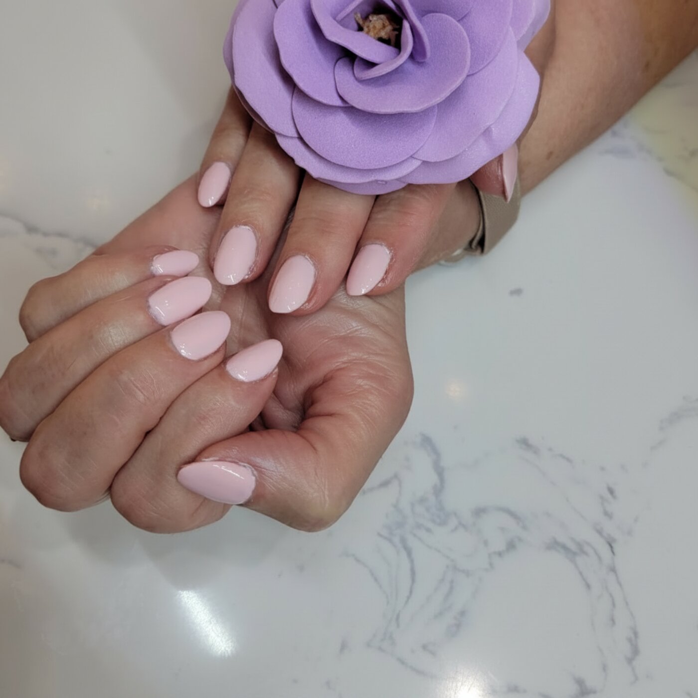 Light pink almond-shaped gel manicure with lavender rose