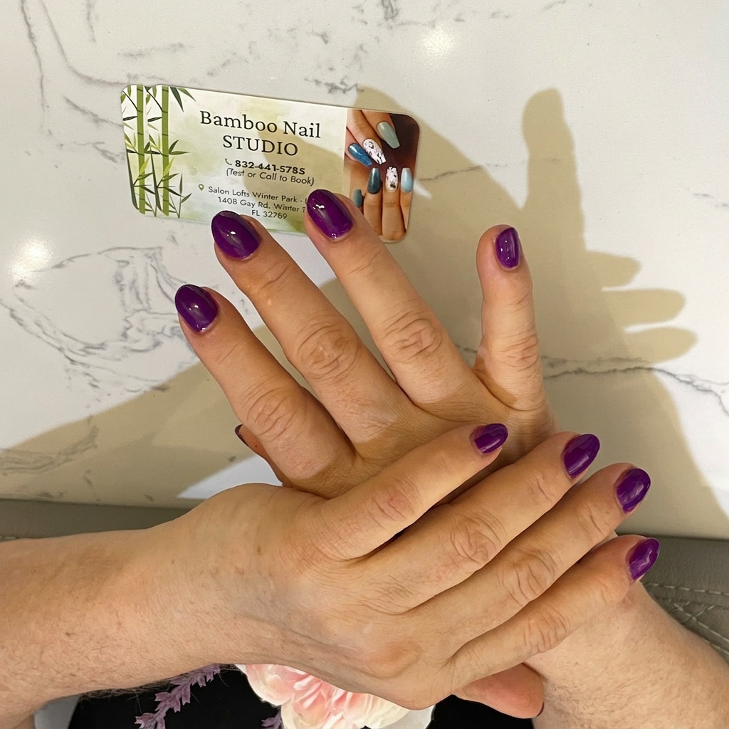 Glossy purple manicure with Bamboo Nail Studio business card